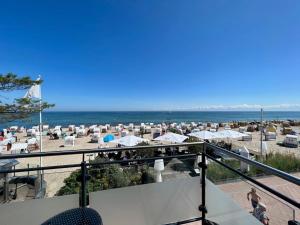 a view of the beach from the balcony of a resort at Seeblick 2 in Dahme