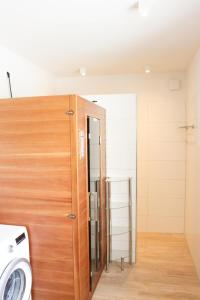 a washer and dryer in a room with a door at Zur Strandwiese W2 in Dahme