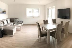 a living room with a couch and a table at Zur Strandwiese W4 in Dahme
