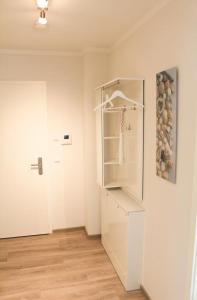 a room with a white book shelf and a door at Zur Strandwiese W4 in Dahme