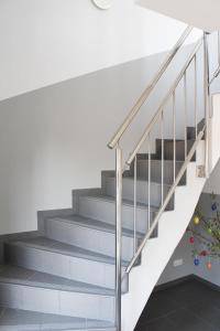 a staircase with a stainless steel railing and a stair case at Zur Strandwiese W4 in Dahme