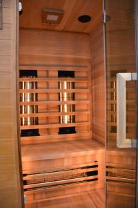 a sauna with wooden walls and a glass door at Zur Strandwiese W3 in Dahme