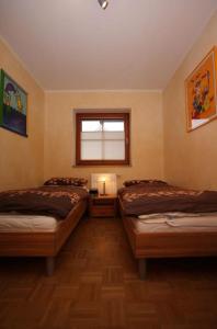 a bedroom with two beds and a window in it at Jacobihof Haus 15 Wohnung 02 in Dahme