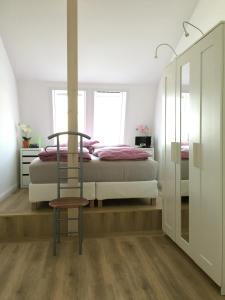 a bedroom with a bed and a chair in it at Seeblick 1 in Dahme