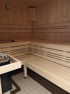 a sauna with wooden benches in a room at Strandhotel Wohnung 2 in Dahme
