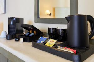 a counter with a coffee pot and other items on it at Sissi Bay Resort in Sissi