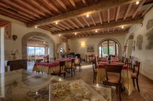 a restaurant with tables and chairs in a room at Agrihotel Il Palagetto in Volterra