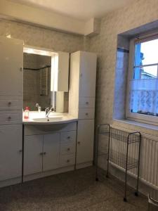 a bathroom with a sink and a mirror and a window at Memelstrasse 6 in Dahme