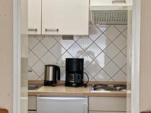 a kitchen with a coffee maker on a counter at Feriengarten Dahme W 1 in Dahme +7 photos