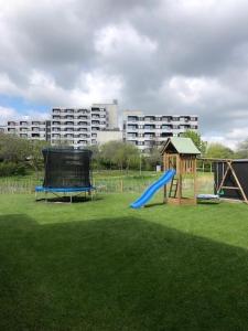 a playground with a blue slide and a play structure at Zur Strandwiese W5 in Dahme