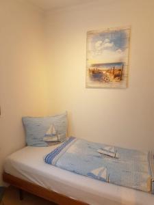 a bedroom with a bed with a picture on the wall at Feriengarten Dahme W 12 in Dahme