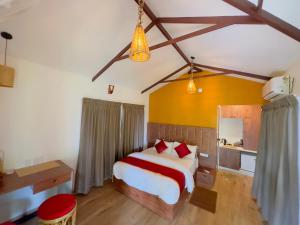 een slaapkamer met een bed en een bureau in een kamer bij Coffee Cradle Wayanad Luxuorios Private Tree House - Inside 2 Acre Coffee Plantation in Mananthavady