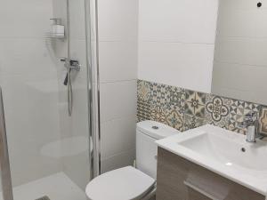a bathroom with a shower and a toilet and a sink at Anduriña in Vigo