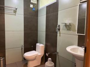 a bathroom with a toilet and a sink at Coffee Cradle Wayanad Luxuorios Private Tree House - Inside 2 Acre Coffee Plantation in Mananthavady