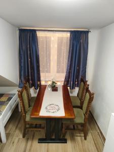 a table and chairs in a room with a window at Kralovak in Králŭv Dvŭr