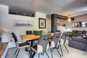 a dining room and living room with a table and chairs at House Zoya in Ližnjan +13 photos