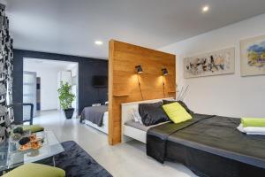 a bedroom with a large bed with a wooden headboard at House Zoya in Ližnjan