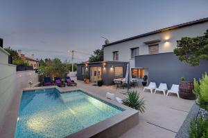 a house with a swimming pool in a backyard at House Zoya in Ližnjan