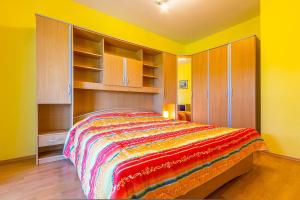 a bedroom with a bed with a colorful blanket at Apartment Eliana in Banjole