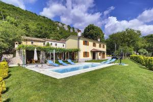 a house with a swimming pool in the yard at Villa Bella in Lupoglav