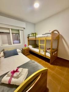 a bedroom with two bunk beds with a pink ribbon at El Charrancito in El Espinar