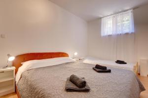 a bedroom with a bed with two towels on it at House Aldo in Banjole +12 photos