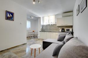 a living room with a couch and a kitchen at House Aldo in Banjole