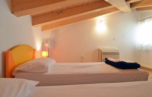 a bedroom with a bed with white sheets and wooden ceilings at Villa Blue II in Banjole