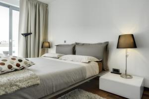 a bedroom with a large bed and a window at Apartment City Business in Pula