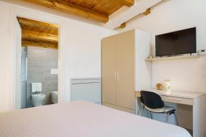a bedroom with a bed and a desk and a bathroom at Tana del Riccio in Ortona