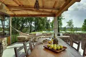 a wooden table with a plate of fruit on it on a patio at Villa Torrecorta in Grožnjan