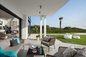 a living room with a couch and chairs on a patio at Villa PS Deluxe in Pula