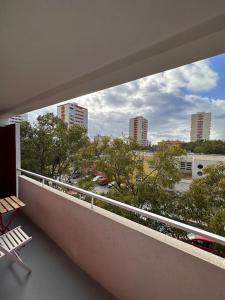 a balcony with a chair and a view of a city at Apartman Trsat in Rijeka