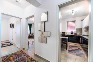 a living room with a cross on the wall at Grandis Coresi Mall Luxury Apartment in Braşov