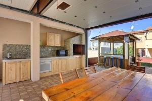 a large kitchen with a wooden table in a room at Nur 150 Meter vom Strand mit Whirlpool in Medulin +13 photos