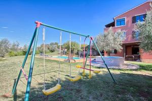 an empty playground with swings in a yard at Traumhaft nur 400 Meter zum Strand in Banjole
