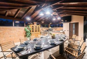 Villa für große Ansprüche mit großem Pool, Sauna, Whirlpool, Billard في ليجيان: غرفة طعام مع طاولة مع أطباق عليها