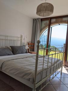 a bedroom with a bed with a view of the ocean at Ferienhaus mit Seeblick und Garten, Pool in ruhiger Lage von Tignale am Gardasee in Tignale