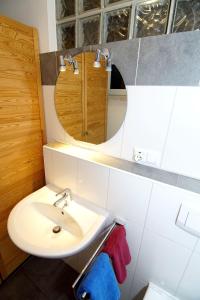 a bathroom with a sink and a mirror at Bungalow Windsbraut in Norddeich