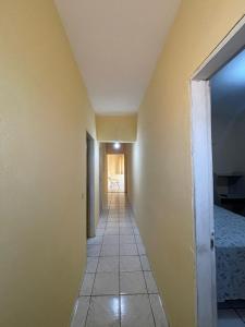 a hallway leading to a room with yellow walls at Hotel Horizonte in Teresina