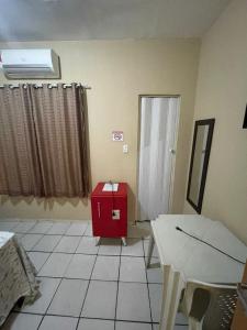 a room with a red cabinet and a window at Hotel Horizonte in Teresina