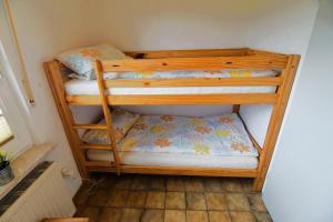 two bunk beds in the corner of a room at Bungalow Jule in Norden