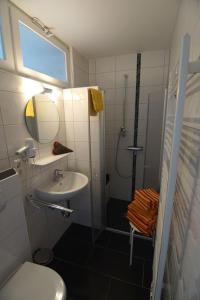 Un baño con inodoro, lavabo y ducha. en Bungalow Hohes Riff, en Norddeich