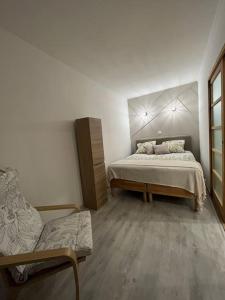 a bedroom with a bed and a couch in it at Appartement Disneyland Paris in Bussy-Saint-Georges