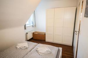 ハーフクルークにあるFerienwohnung Kutter Haus Duckdalbenのベッドルーム1室(ベッド1台、タオル2枚付)