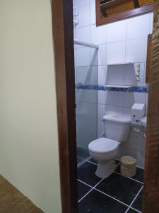 a bathroom with a white toilet and a sink at Pousada Portal da Mucugê in Porto Seguro