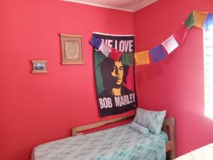 a bedroom with a bed and a sign that says we love the boston bru at TOGA GUEST HOUSE in Port Antonio