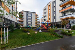 a park with a playground in the middle of a city at Grandis Residence Apartment in Braşov