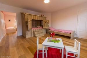 a living room with a table and chairs and a bedroom at Ferienhaus Rote Sau in Herrentierbach
