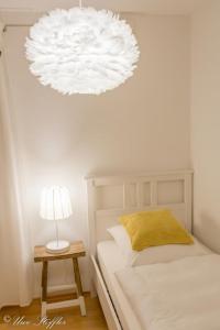 a bedroom with a bed and a lamp on a table at Ferienwohnung Maierers Schaiere in Gammesfeld